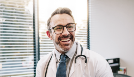 Locum provider smiling at desk