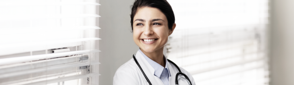 Doctor looking out the window and smiling