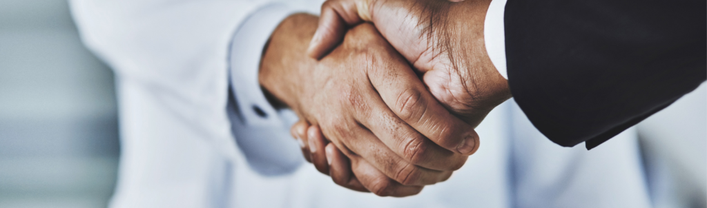 Locum tenens doctor shaking hands with business man