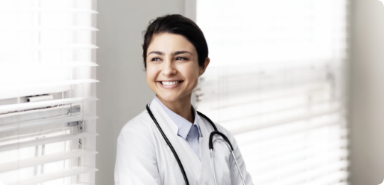 Physician looking out window and smiling