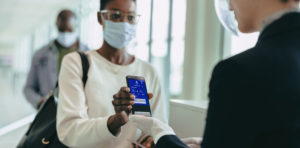 A person wearing a mask at airport about to board their flight.