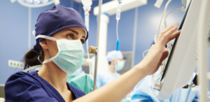 Image of a CRNA updating a machine.