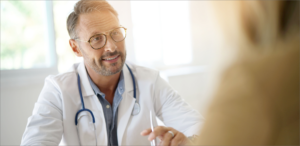 Doctor talking with patient in hospital